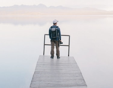 Man standing near the edge of a lake
