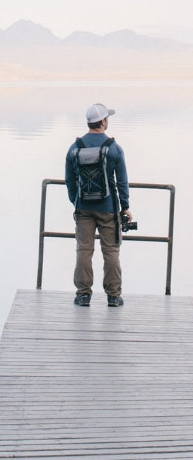 Man standing near the edge of a lake