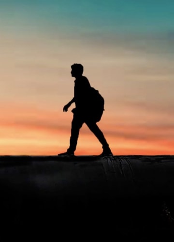 A man hiking in the sunset